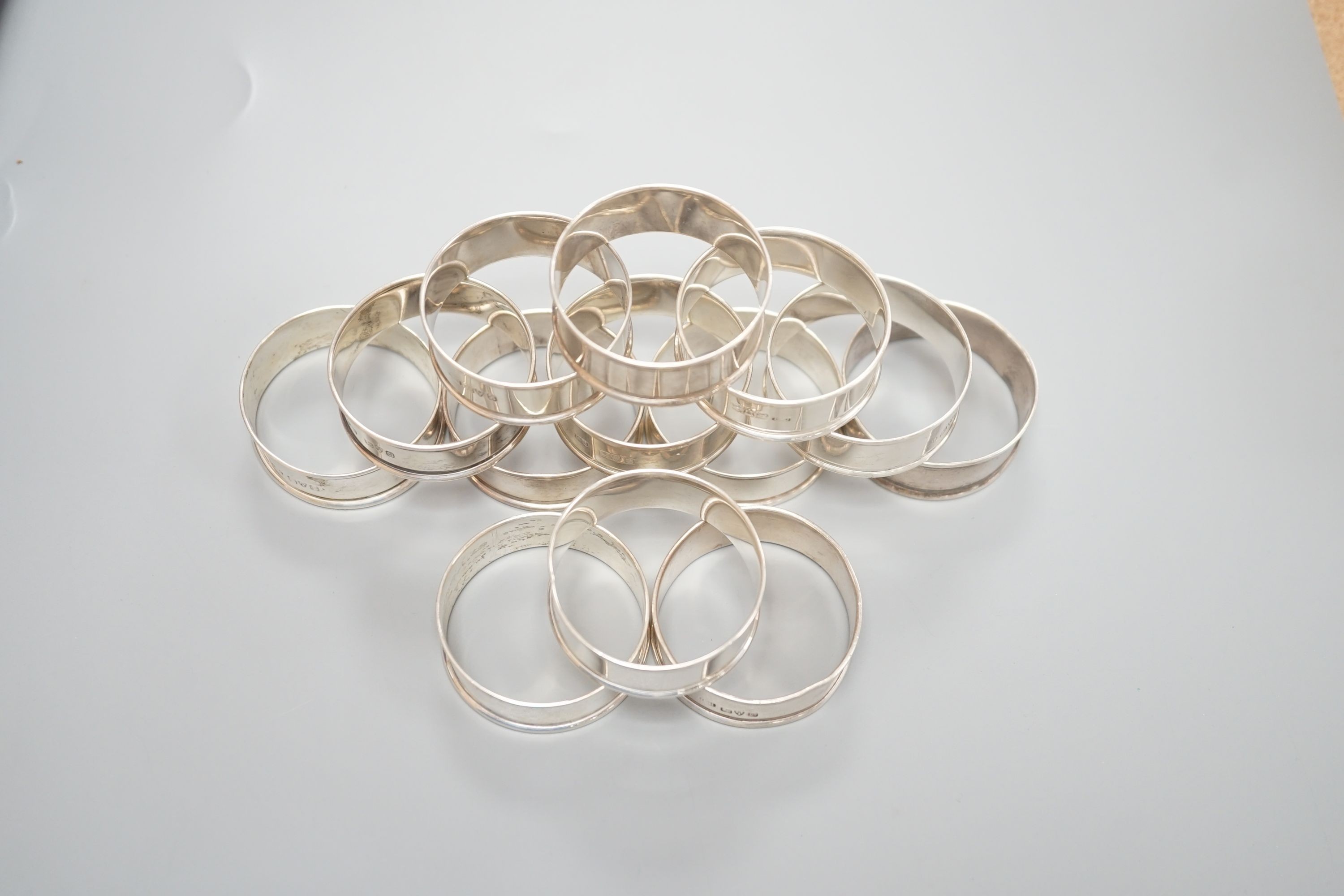 A matched set of thirteen early 20th century plain silver napkin rings, by Charles Horner, Chester, various dates.